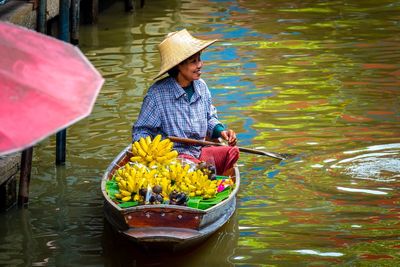 Woman in boat at lake