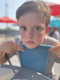 Portrait of boy holding mobile phone