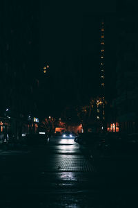 Illuminated city street at night