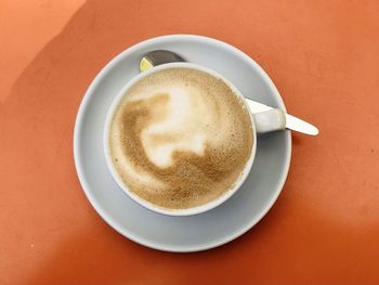 Directly above shot of cappuccino served on table