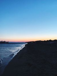 Scenic view of sea against clear sky during sunset