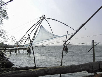 Suspension bridge over sea against sky