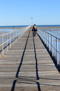 Pier on sea against clear sky