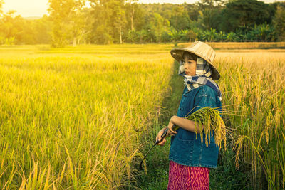 Girl standing on rice field