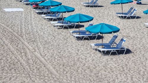High angle view of lounge chairs on beach