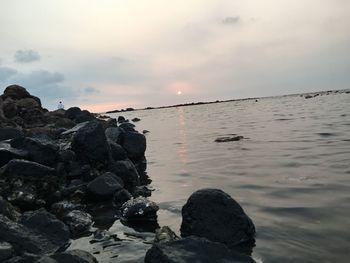 Scenic view of sea against sky at sunset