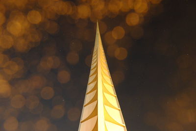 Low angle view of illuminated building against sky at night