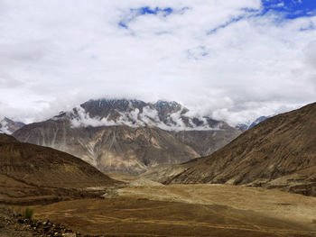 Scenic view of mountains against cloudy sky