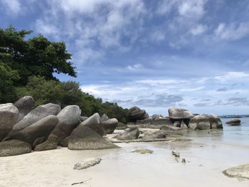 Rocks on shore against sky