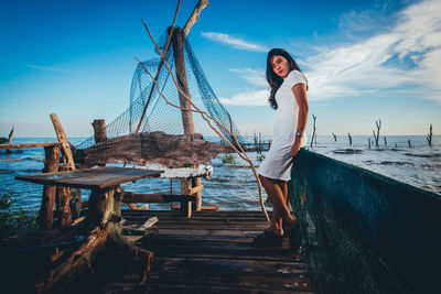 Full length of woman standing on pier