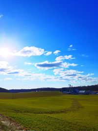 Scenic view of field against blue sky