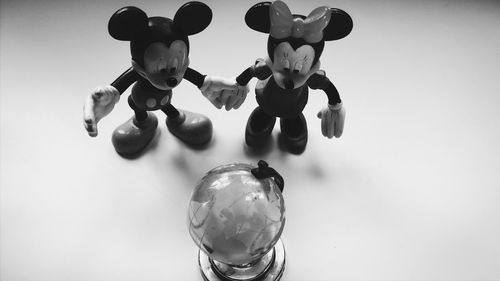 Close-up of toys on glass against white background