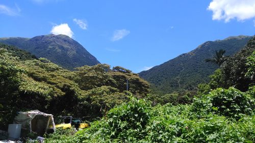 Scenic view of mountains against blue sky