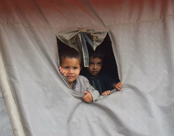 Portrait of cute boys in tent