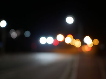 Defocused image of illuminated city at night