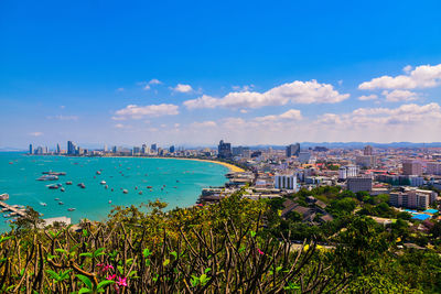 High angle view of buildings by sea against sky