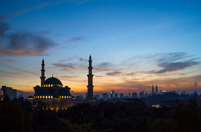 Federal territory mosque against cloudy sky at dusk