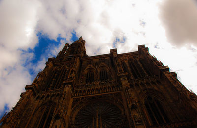 Low angle view of cathedral against cloudy sky