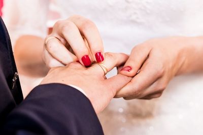 Midsection of couple holding hands\