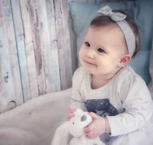 Portrait of cute baby girl with cat