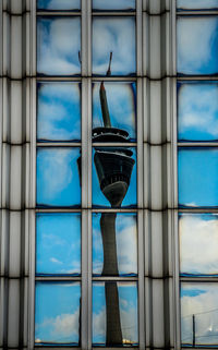 Low angle view of glass building against sky