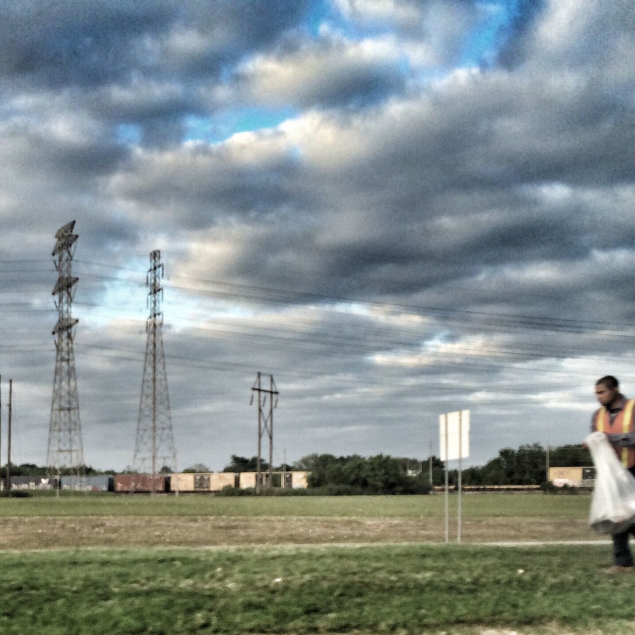 sky, lifestyles, cloud - sky, leisure activity, cloudy, men, cloud, full length, standing, casual clothing, grass, field, side view, person, rear view, overcast, outdoors
