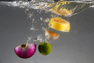 High angle view of fruits in glass over water