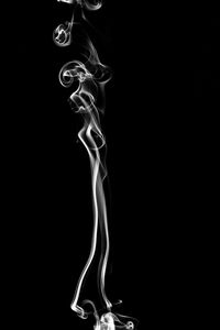 Close-up of lamp over black background