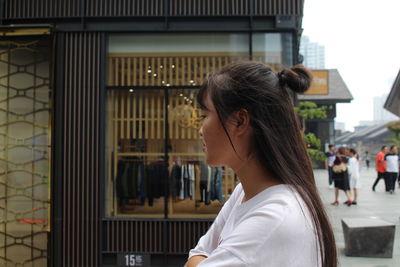 Close-up of woman standing in front of building