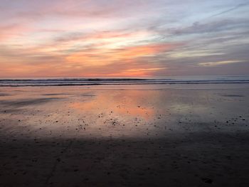 Scenic view of beach against sky during sunset