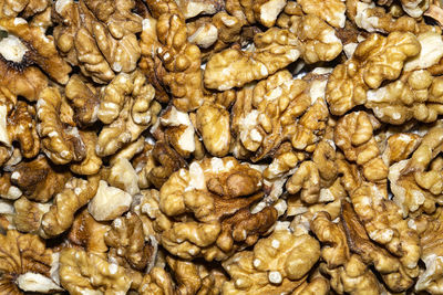 Close up background with peeled walnuts, macro photo.