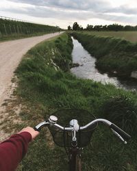 Close-up of hand holding bicycle handle