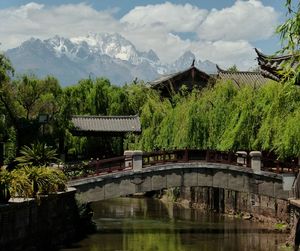 Scenic view of river and mountains against sky