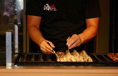 Midsection of man preparing food on table