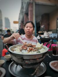 Midsection of woman having food in restaurant