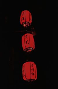 Close-up of illuminated lantern over black background