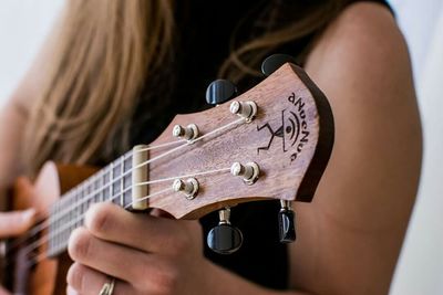 Cropped image of man playing guitar