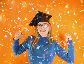 Portrait of woman with arms raised