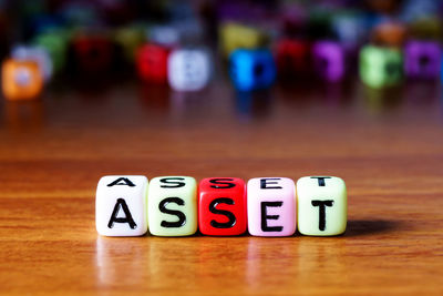 Close-up of text on multi colored toy blocks table