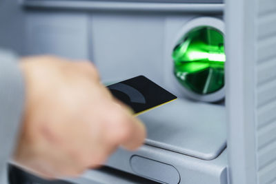 Businessman using credit card at atm machine