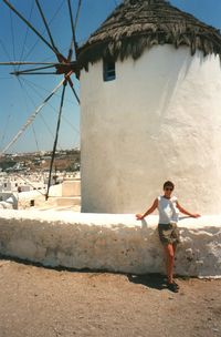 Full length of woman standing against built structure