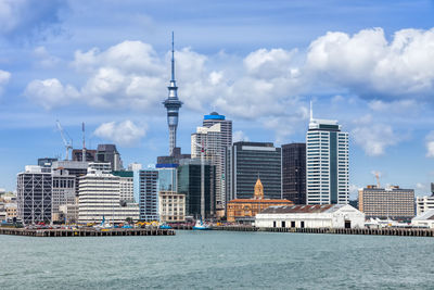 Modern buildings in city against cloudy sky