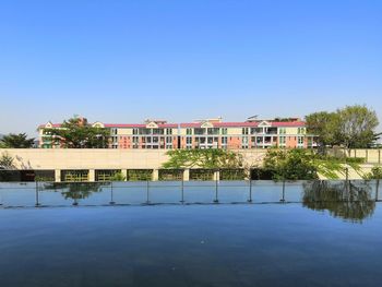 View of swimming pool by lake against sky