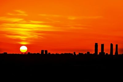 Scenic view of silhouette landscape against orange sky