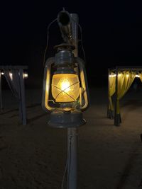 Close-up of illuminated light bulb at beach