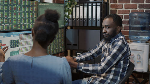 Side view of man looking at table