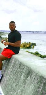 Portrait of smiling young man on beach