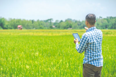 Side view of man using digital tablet