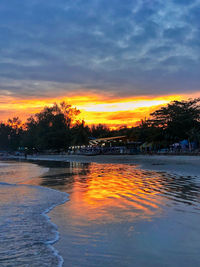 Scenic view of lake against romantic sky at sunset