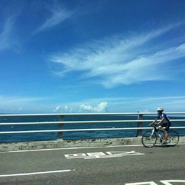 bicycle, transportation, mode of transport, men, land vehicle, railing, lifestyles, leisure activity, sky, riding, full length, road, sunlight, cycling, street, walking, person, on the move